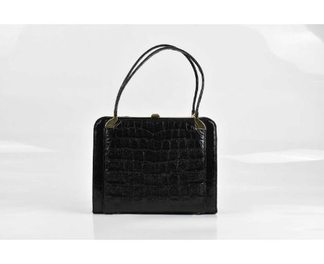 ESTEVE; a vintage black crocodile skin handbag, with gold tone hardware, two top handles and leather interior, with original 