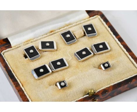 A cased set of onyx and seed pearl mounted cufflinks and button studs, inscribed to the reverse 'Platinum &amp; Gold'.Conditi