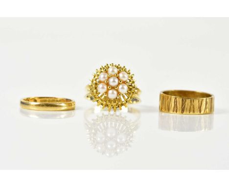 An 18ct yellow gold wedding band, size K 1/2, approx 2.3g, and two decorative dress rings (3).
