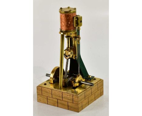A scratch built live steam vertical engine, single piston, on wooden plinth base, height 24cm.