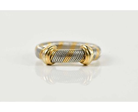 CARTIER; a two tone ribbed ring, with yellow metal bands, signed, numbered 443503, Cartier size 50, size K, approx 5.3g.