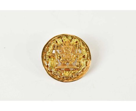 A pierced yellow metal combination brooch/pendant, with Aztec design, diameter 27mm, approx 8.6g.