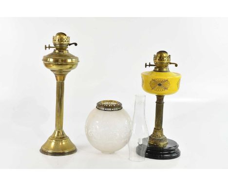 A late Victorian oil lamp with yellow glass reservoir and a further brass oil lamp (2).