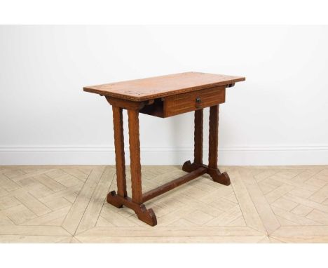 A carved light oak Gothic table, with drawer, on standard end supports, height 72.5cm, width 91cm, depth 45.52cm.