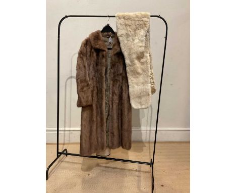 SOVEREIGN FURS; a full length light brown mink coat with small collar and a short cream fur coat with original clothing cover