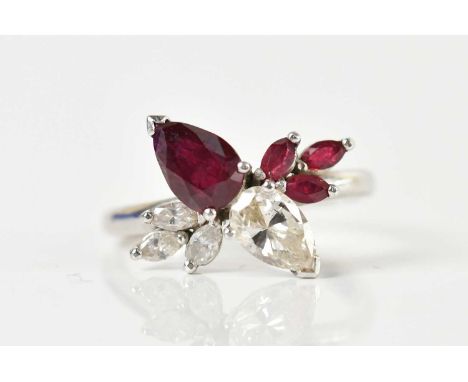 A white metal ruby and diamond dress ring, the twin pear cut central diamonds and rubies each weighing approx 0.60ct, with th