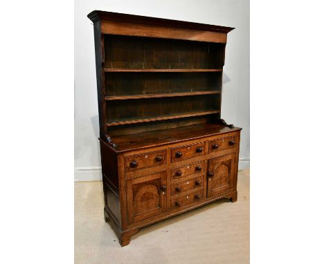 A George III oak and pine Welsh dresser, the raised back with three shelves, above an arrangement of six drawers and two pane