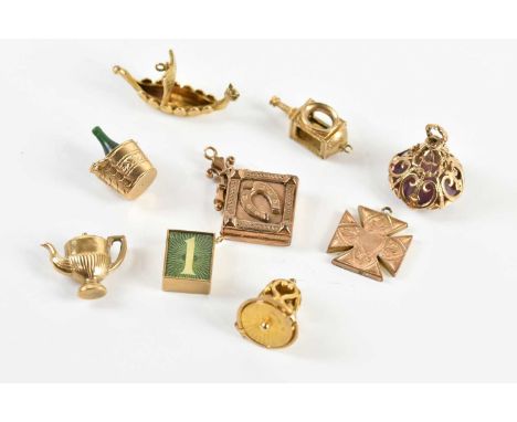 A collection of 9ct yellow gold charms and fobs, including a longboat, lantern etc, approx. 14.7g, with a 9ct gold money char