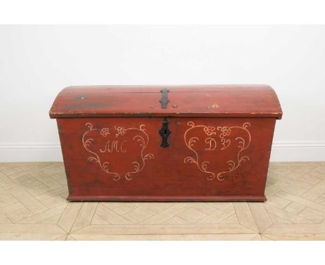 A Scandinavian red painted pine dome top trunk, with side handles, height 66.5cm, width 129.5cm, depth 63cm.