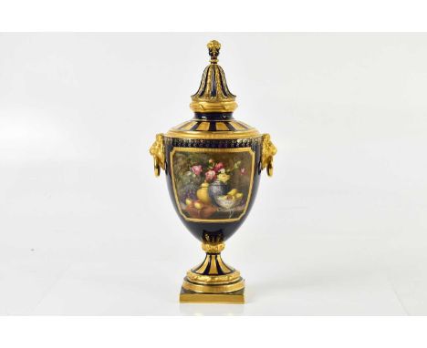 WILLIAM HAWKINS FOR ROYAL WORCESTER; a large hand-painted pedestal urn vase and cover, with moulded lion mask handles support