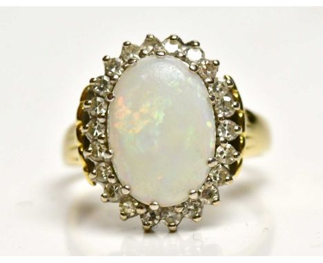 An 18ct yellow gold opal and diamond set oval ring, size Q, approx 7.3g, the ring head 17.8 x 14.8mm.Condition Report: The op