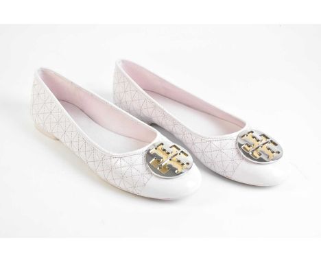 TORY BURCH; a pair of unworn light pink quilted Nappa leather flat pumps, with large silver and gold tone front logo of maker