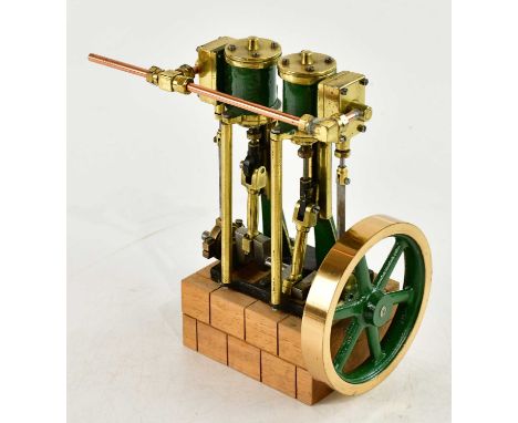 A scratch built live steam vertical twin piston engine, on wooden plinth, height 20cm. 