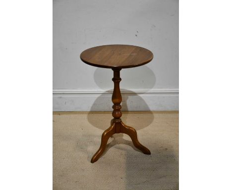 ERCOL; a medium elm tripod table, height 75cm.