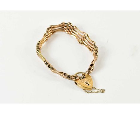 A 9ct yellow gold textured gate link bracelet with padlock clasp, approx 12g.