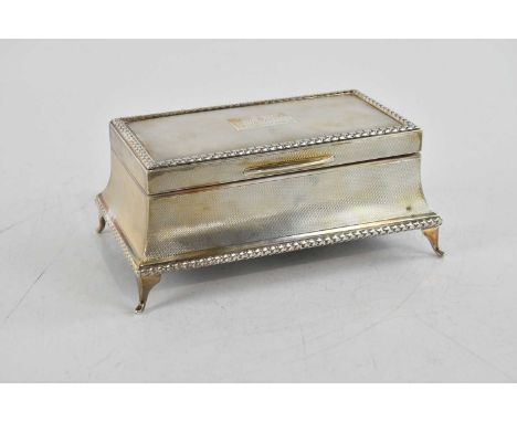 JOSEPH GLOSTER; an Elizabeth II hallmarked silver cigarette box of shaped rectangular form, with engine turned decoration and