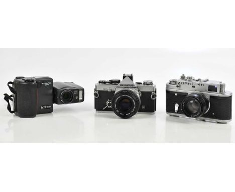 Three cameras, including a Zorki-4K rangefinder camera with a Jupiter-B 50mm f2 lens, an Olympus OM-2n 35mm film camera with 