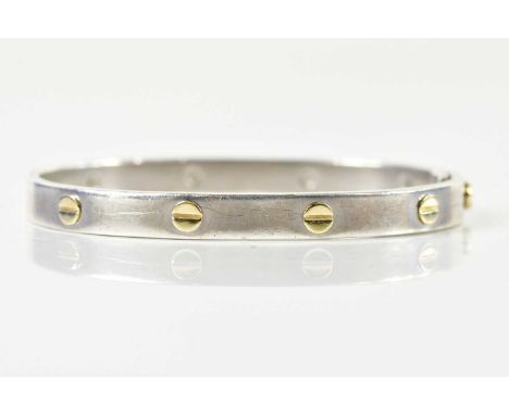 A silver oval hinged bangle after the original design by Cartier, internal width 60mm, approx 28.9g.