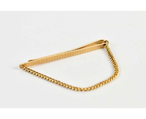 A 9ct yellow gold tie clip, with yellow metal suspension chain, combined approx 7.5g.