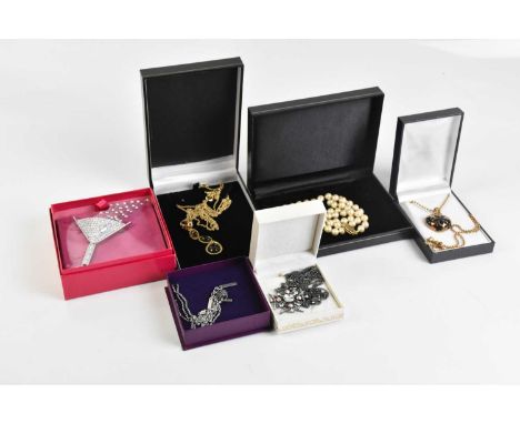 BUTLER &amp; WILSON; a large diamanté cocktail glass brooch, unopened and boxed, a gunmetal diamanté pendant, a set of Monet 