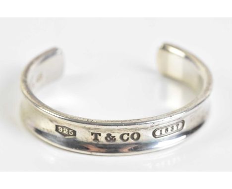 TIFFANY &amp; CO 1837; a hallmarked silver bangle, marked 'Tiffany &amp; Co 1837', in original box, approx 42.3g.  