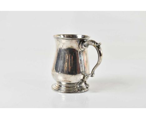 A George III hallmarked silver baluster mug, with simple scroll loop handle and spreading circular foot, London 1770, height 