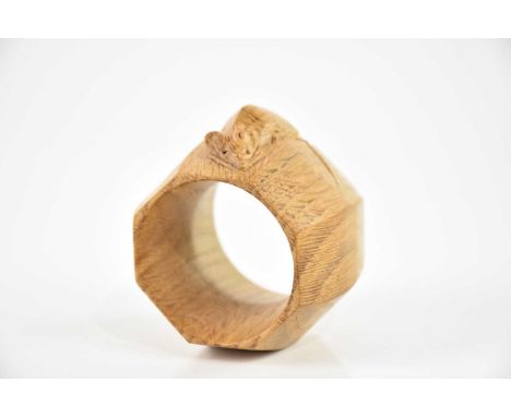 WORKSHOP OF ROBERT MOUSEMAN THOMPSON; an adzed oak octagonal napkin ring, height 5cm.