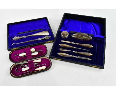 E J TREVITT &amp; SONS; a George V hallmarked silver handled manicure set, Chester 1922, with plated button hook and shoe hor