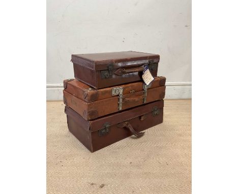 Three vintage brown leather suitcases including a tan brown leather Finnigans of London example, with silver tone metal closu