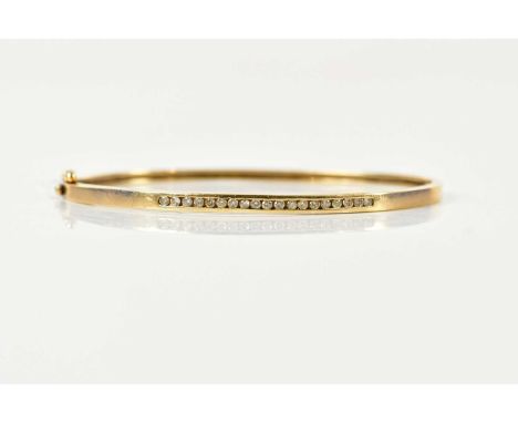 A 9ct yellow gold oval hinged snap bangle, channel set with a row of small round brilliant cut diamonds, internal width 60mm,