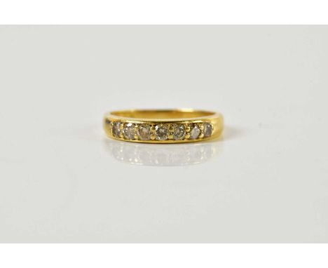 An 18ct yellow gold seven stone diamond half eternity ring, the round brilliant cut stones totalling approx 0.50ct, size K, a