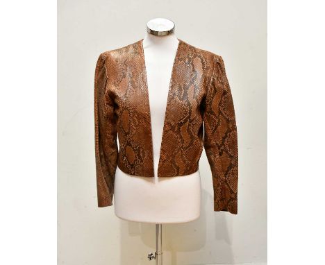 YVES SAINT LAURENT; a short python snakeskin vintage bolero jacket, fully lined in beige satin, size 34, UK 8/10.Condition Re