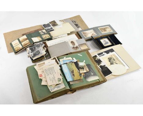 A large collection of Victorian and later postcards and ephemera, contained in albums and loose, various scenes including Tra