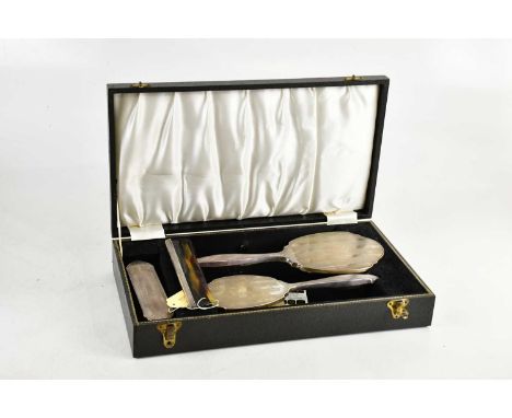 W I BROADWAY; a cased Elizabeth II hallmarked silver four piece dressing table set with engine turned decoration, Birmingham 