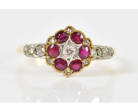 An 18ct yellow gold diamond and ruby ring, with circular central platform and rose cut diamonds flanking, size M, approx 2.2g