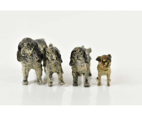 An early 20th century cold painted bronze miniature model of a pug, length 3cm, and a set of three cold painted bronze models