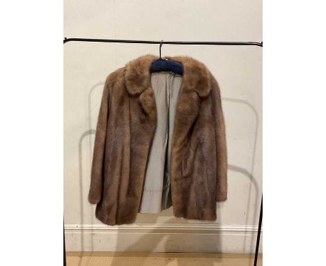 A short light brown mink fur coat, fully lined, with collar, satin lining with Sovereign logo, measures 40" chest.
