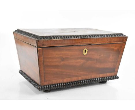 A large 19th century mahogany tea caddy, with moulded border, the hinged cover enclosing six compartments, on bun feet, width