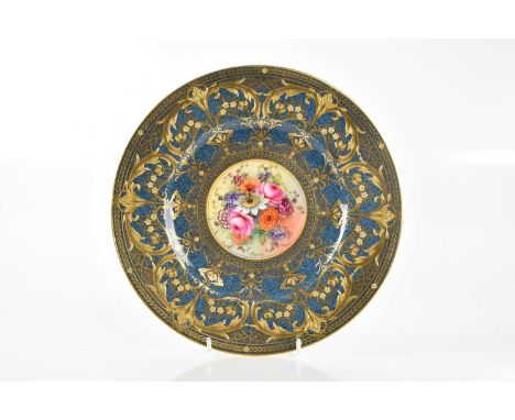 E BERKELEY FOR ROYAL WORCESTER; a fine hand painted cabinet plate of circular form, the central cartouche painted with floral