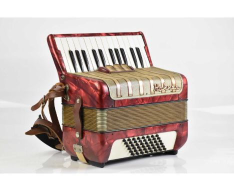 A Hohoner accordion with red marble effect finish.