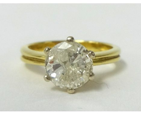 An 18ct gold diamond solitaire ring, size M , the stone approximately 1.50 ct, J-K colour, P2 clarity together with a copy of