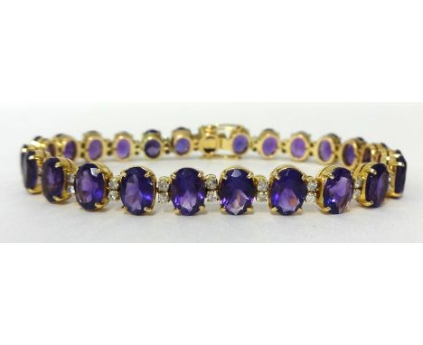 A fine amethyst and diamond bracelet set with approximately twenty five stones, 19cm long.