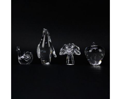 Group of Four (4) Steuben Crystal Figurines. Includes Penguin, 6-1/4" H; apple, 4" H; snail, 3-1/3" H; mushroom, 4" H. All pi