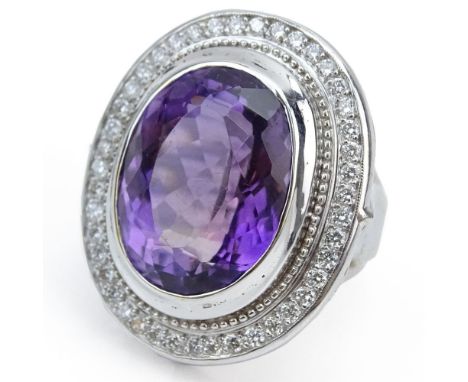 Large Oval Shape Amethyst, Round Brilliant Cut Diamond, and 14 Karat White Gold Ring. Amethyst measures 20 x 16mm. Unsigned. 