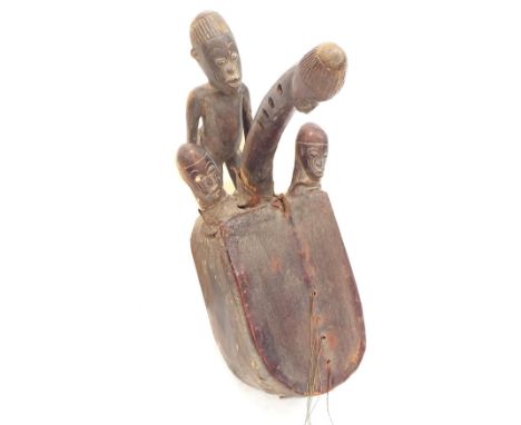 Interesting early 20th century African phallic tribal bow harp, with hide soundboard upon a carved hardwood bowl back surmoun