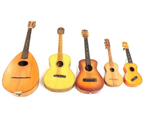 Italian pear shaped guitar lute labelled Monzino &amp; Figli..., in need of some restoration; together with three small guita