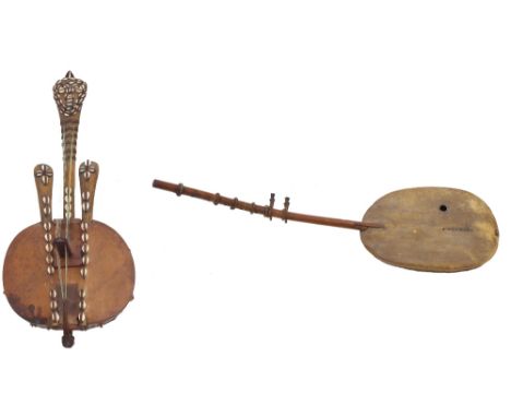 Interesting West African twelve string kora harp, with hide covered gourd back and decorated with cowrie shells; together wit