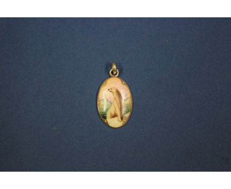 A silver and enamel pendant of a polar bear.