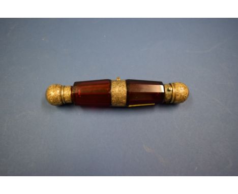 An unusual Victorian faceted ruby glass double ended scent bottle, by S Mordan & Co, with gilt mounts, decorated crest and in
