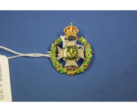 A silver gilt and enamel 'Rifle Brigade' brooch.